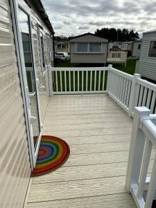 a deck with a rainbow rug on a house at Seton Sands St Andrews in Port Seton