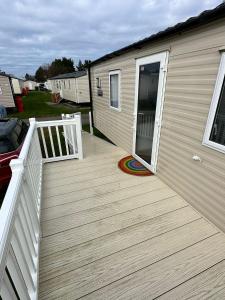 a wooden deck with a door on a house at Seton Sands St Andrews in Port Seton