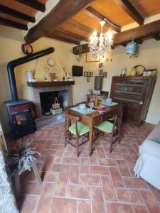 - un salon avec une table et une cheminée dans l'établissement La casetta della nonna, à Caprese Michelangelo