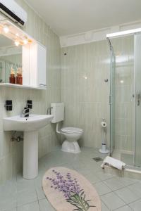 a bathroom with a sink and a toilet and a shower at Guest House Tomasi in Dubrovnik