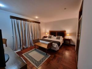ein Schlafzimmer mit einem Bett und einem Tisch in einem Zimmer in der Unterkunft Terrazas Vista Verde in Asunción