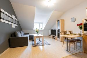 a living room with a couch and a table at Apartament Perłowy z balkonem- Dream Apart in Ustroń
