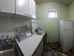 a kitchen with a sink and a refrigerator at JANS дача in Chimgan