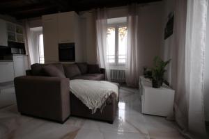 a living room with a couch and a window at casa airuno in Airuno