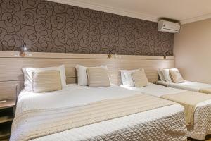 Postel nebo postele na pokoji v ubytování Hotel Pousada Kaster