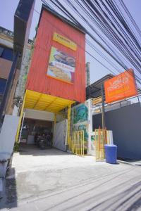 a building with a sign on the side of it at Capsule Inn Bali in Legian