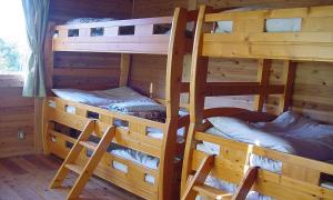 two bunk beds in a log cabin at Maetakeso in Yakushima