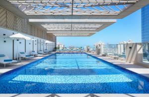 a swimming pool on the roof of a building at Cheval Maison - The Palm in Dubai
