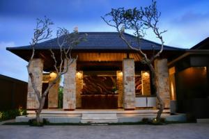 a home with two trees in front of it at Villa Ava Seminyak Bali in Seminyak