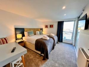 a hotel room with a bed and a balcony at Tolbooth Apartments by Principal Apartments in Glasgow