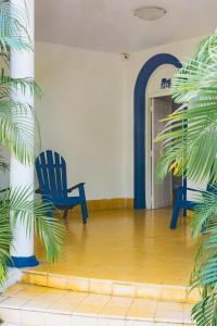 a room with two blue chairs in front of a door at Casa Colonial en Manga in Cartagena de Indias