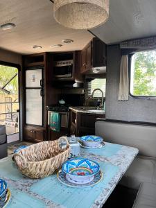 a kitchen with a table with blue and white dishes on it at RV Paradise on the Wheels at Clearwater Beaches in Largo