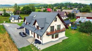 an aerial view of a house with a roof at Apartamenty i Domki Orawskie in Zubrzyca Dolna