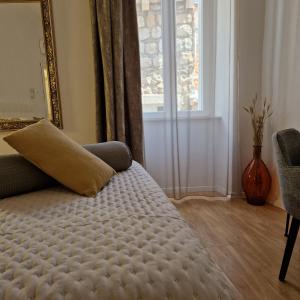 a bedroom with a couch and a window at Villa Homa in Dubrovnik