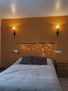 1 dormitorio con 1 cama con luces en la pared en Casa Txillarenea en Igantzi