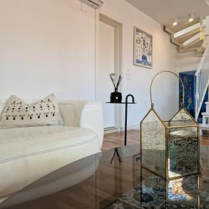 a living room with a white couch and a glass table at Villa Homa in Dubrovnik