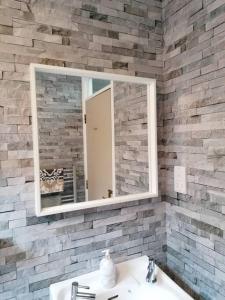 a bathroom with a mirror and a sink at Stunning 3 Bedroom townhouse in the heart of city in Belfast