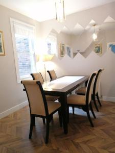 a dining room with a table and chairs at Stunning 3 Bedroom townhouse in the heart of city in Belfast