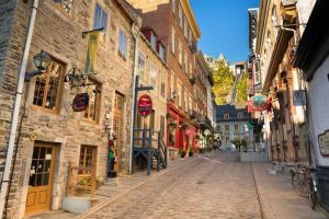 a cobblestone street in an old town with buildings at Penthouse With FREE indoor Parking Downtown in Quebec City