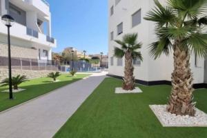 two palm trees in front of a building at Sun-Golf-Beach Villamartin in Alicante