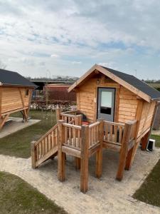 een houten hut met twee banken ervoor bij Hoogte Huisje Schotland in Swalmen