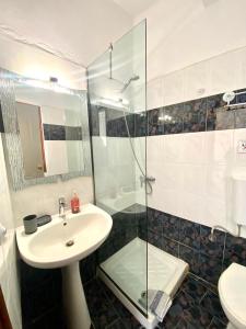 a bathroom with a sink and a glass shower at Costas Inn in Spílion