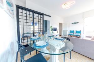 a dining room with a glass table and chairs at [Vista Mare Portofino] Terrazza • Free Parking • Wi-fi in Rapallo