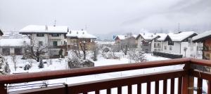 a view of a snow covered city with houses at Casa Hena in Croviana