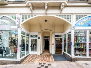 a store front with an archway in a street at Pass the Keys Stylish and bright City Centre apartment in Exeter