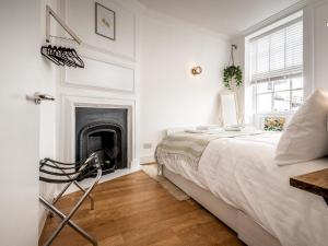a bedroom with a bed and a fireplace at Pass the Keys Stylish and bright City Centre apartment in Exeter