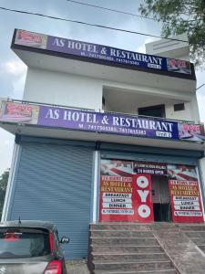 a store with signs on the front of a building at OYO As Hotel And Restaurant Unit 2 in Meerut