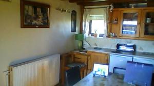 a kitchen with a sink and a counter top at Old Coach House in Matlock +55 photos