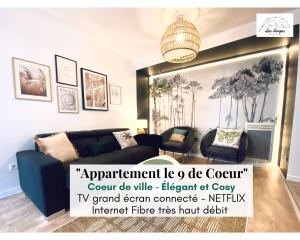 a living room with a blue couch and a chandelier at Le 9 de Cœur - Hyper Centre Arras - 6 voyageurs- Spacieux 75m2 - 2Ch in Arras