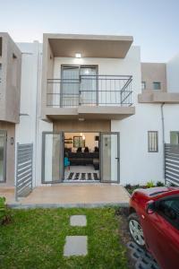 a house with a balcony and a living room at Le Palmiste lovely 2-bedroom duplex with pool in Grand Gaube