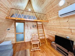 a room with a bunk bed and a ladder at Alex's House Shirokë in Shkodër