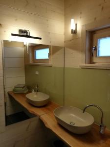 a bathroom with two sinks on a wooden counter at Ferienhaus-Eisenerz in Eisenerz