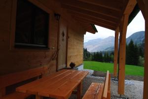 a wooden bench on the porch of a cabin at Ferienhaus-Eisenerz in Eisenerz