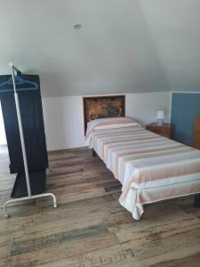 a bedroom with two beds and a flat screen tv at House Tempa la pera in Alfano
