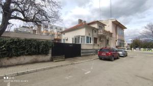 a car parked in a parking lot in front of a house at Вила Радеви in Obzor