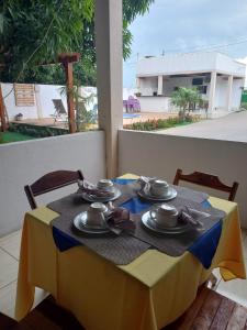 a table with a yellow and blue table cloth at HELLO MT POUSADA in Nobres