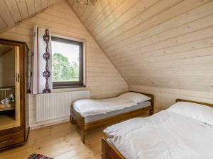 a attic room with two beds and a window at Domek Orawski in Zubrzyca Dolna
