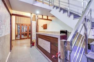 a hallway with a staircase and a stair case at Super OYO Hotel Olive in Rohtak
