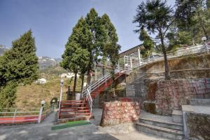 a staircase leading up a hill with trees at OYO Pine Tree in Mussoorie