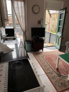 a living room with a flat screen tv and a large window at Gites in Le Neufbourg -Mortain in Le Neufbourg