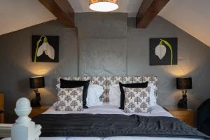 a bedroom with a bed with white sheets and pillows at Gill Cottage, Castle Carrock, Nr Carlisle in Castle Carrock