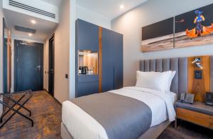 a bedroom with a large white bed and a desk at Onyx City Center in Tbilisi City
