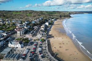 an aerial view of a beach with cars parked at Beach Court - 1 Bedroom Apartment - Saundersfoot in Saundersfoot