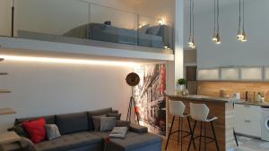 a living room with a couch and a kitchen at Brand New sunny apartment on Andrássy street in Budapest