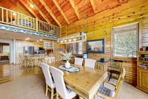 a dining room with a wooden table and chairs at Joining Families at Bear Lake in Garden City