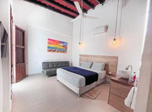 a bedroom with a bed and a sink in it at Comunidad Calle 13 Hotel Boutique in Santa Marta